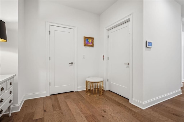 interior space with baseboards and wood finished floors