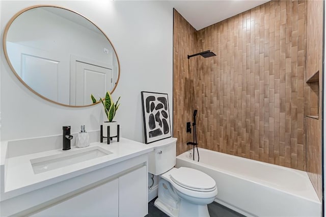 full bathroom featuring tiled shower / bath combo, vanity, and toilet