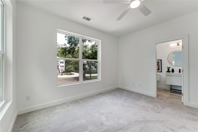 unfurnished bedroom featuring ceiling fan and light carpet