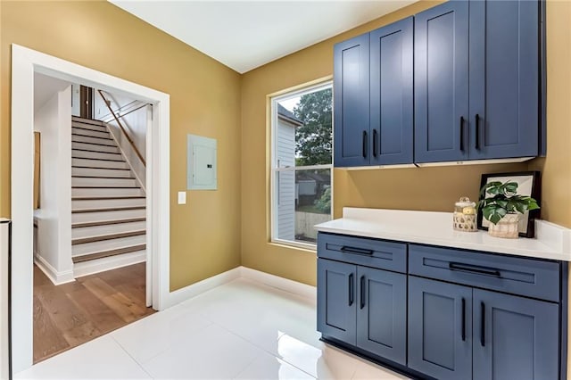 interior space with blue cabinets and electric panel