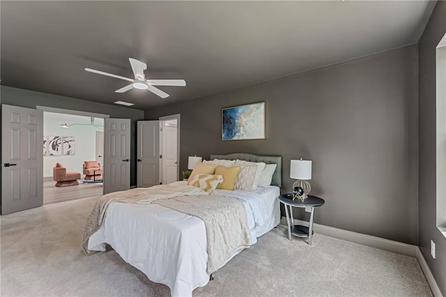 bedroom featuring light colored carpet and ceiling fan