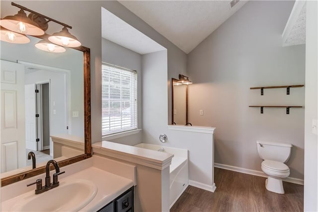 926 Masters Dr, Monroe, GA 30655 - full bath with vaulted ceiling, vanity, wood finished floors, and a bath