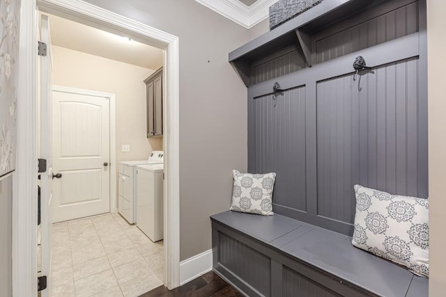 mudroom with washer and clothes dryer, ornamental molding, and light tile patterned flooring