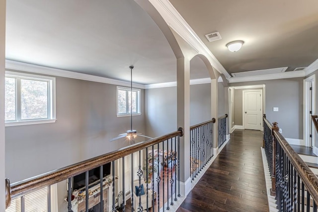 hallway featuring dark hardwood / wood-style flooring and crown molding