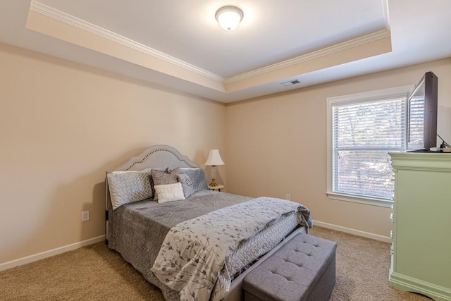 carpeted bedroom with a raised ceiling and crown molding