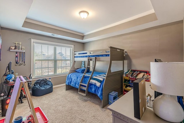 bedroom with carpet flooring, a raised ceiling, and crown molding