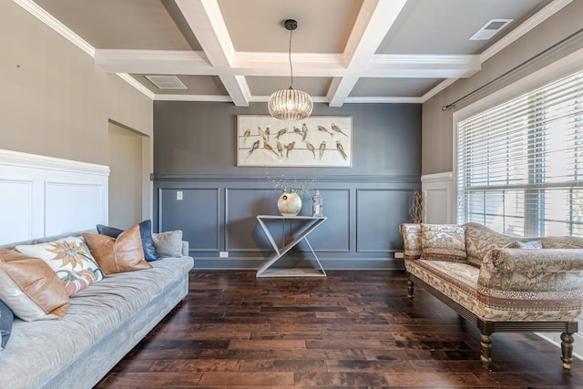 sitting room with beam ceiling, dark hardwood / wood-style floors, ornamental molding, and coffered ceiling