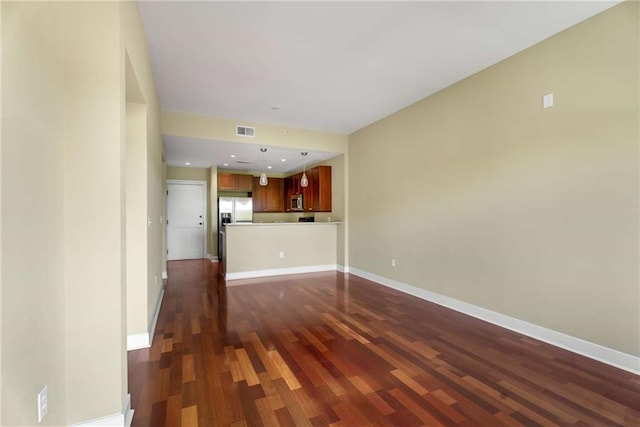 unfurnished living room featuring dark wood-style floors and baseboards