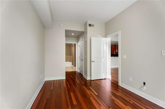 unfurnished bedroom with baseboards and wood finished floors