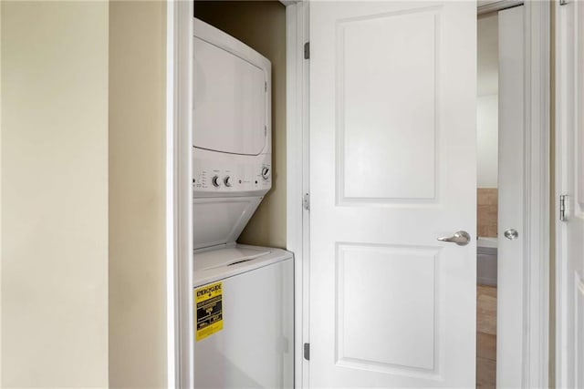 washroom with stacked washer / drying machine