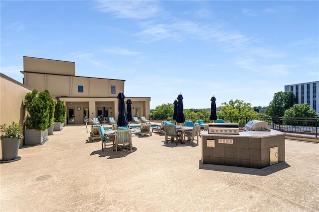 view of patio / terrace with an outdoor kitchen, grilling area, and fence