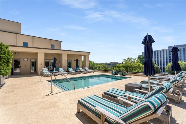 community pool featuring a patio area and fence