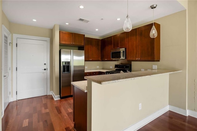 kitchen with appliances with stainless steel finishes, a peninsula, dark wood finished floors, pendant lighting, and baseboards
