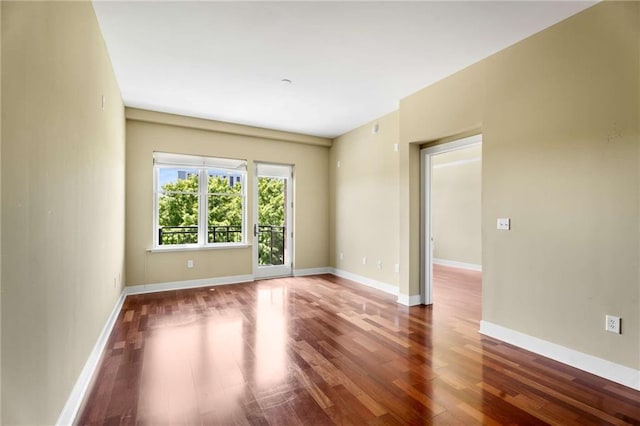 unfurnished room featuring wood finished floors and baseboards