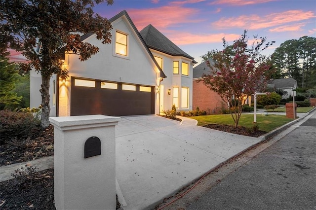 view of front of home featuring a garage and a yard