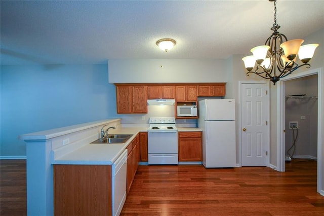 150 Old Mill Rd Unit 115, Cartersville, GA 30120 - kitchen featuring white appliances, a chandelier, dark wood-type flooring, light countertops, and under cabinet range hood