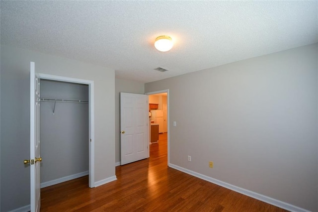 150 Old Mill Rd Unit 115, Cartersville, GA 30120 - unfurnished bedroom with wood finished floors, a closet, and a textured ceiling