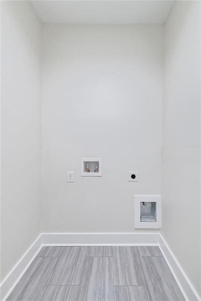 laundry room featuring washer hookup, light hardwood / wood-style floors, and hookup for an electric dryer