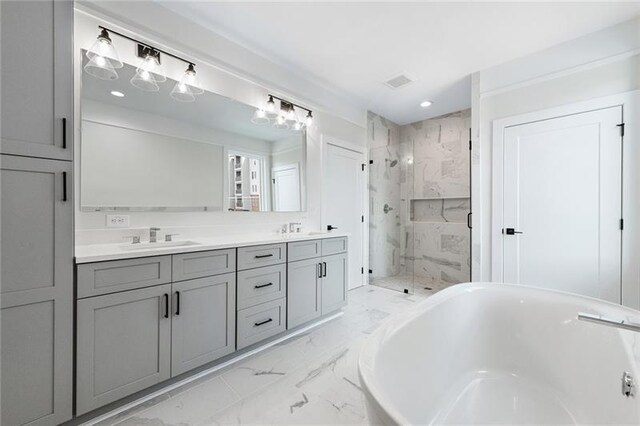 bathroom with vanity and separate shower and tub