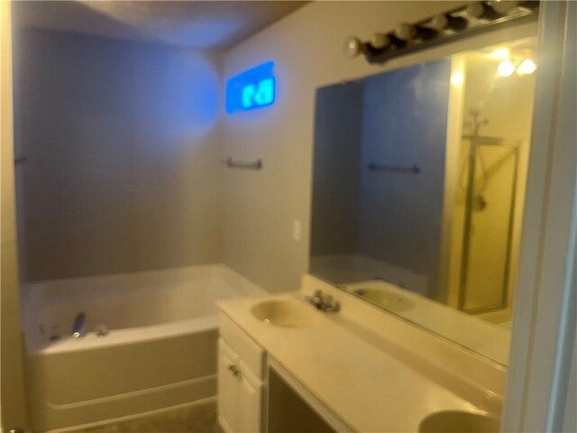 full bath featuring a bath, double vanity, and a sink