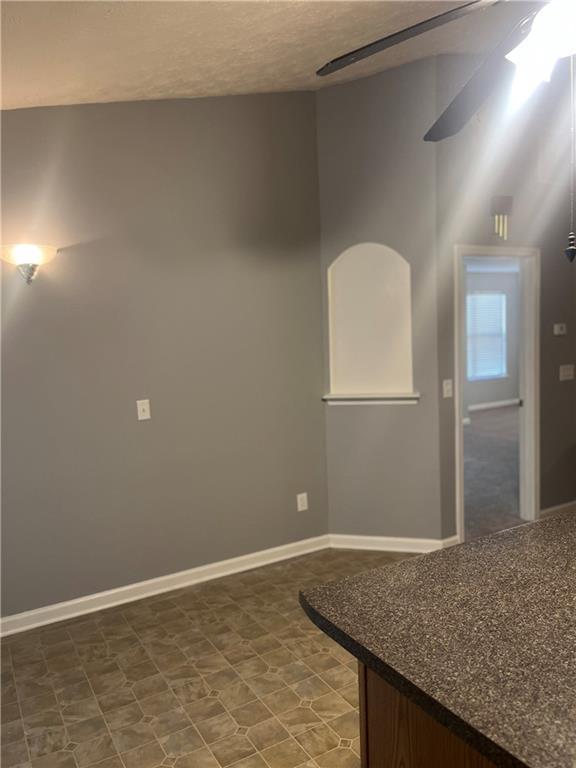 empty room featuring baseboards and a textured ceiling