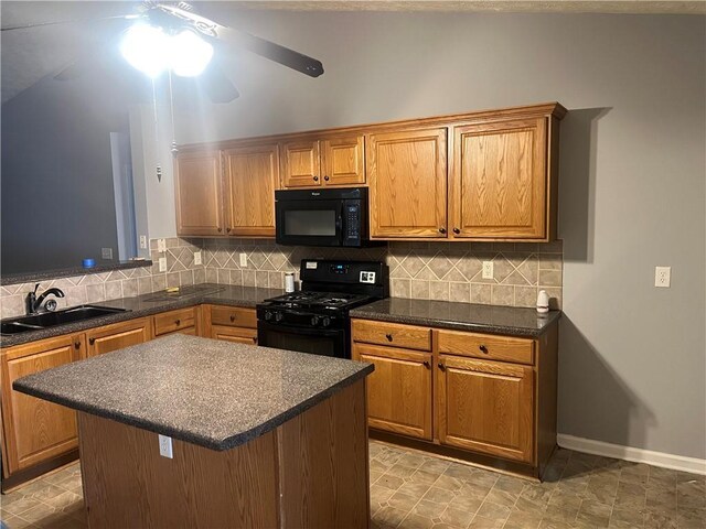 kitchen with a sink, decorative backsplash, black appliances, and dark countertops