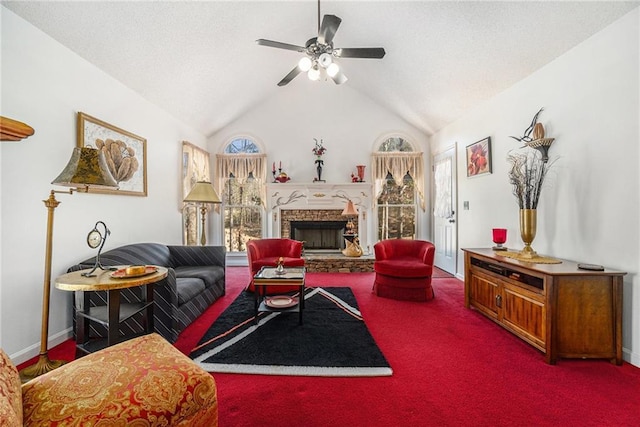 living area with baseboards, carpet, lofted ceiling, a stone fireplace, and a ceiling fan