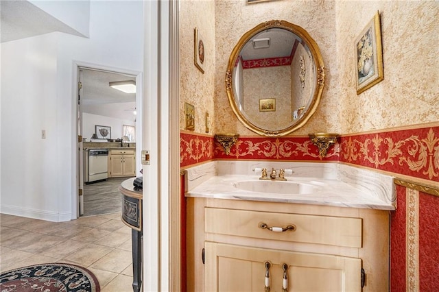 bathroom featuring vanity, baseboards, wallpapered walls, tile patterned flooring, and a textured ceiling