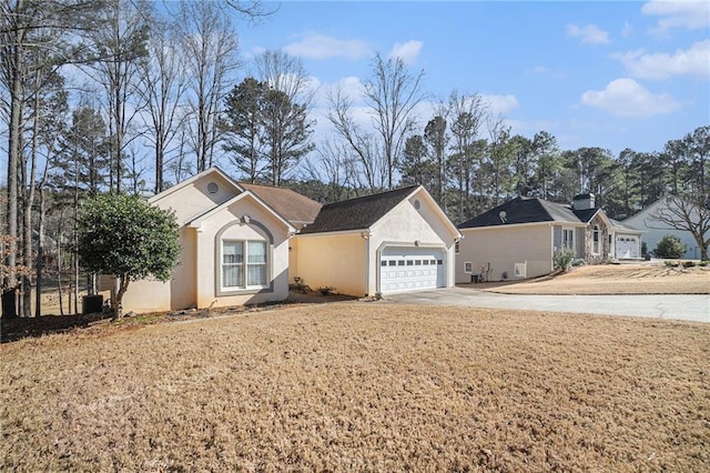 ranch-style house featuring stucco siding, an attached garage, and concrete driveway