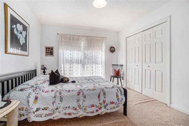 carpeted bedroom featuring a closet and a textured ceiling