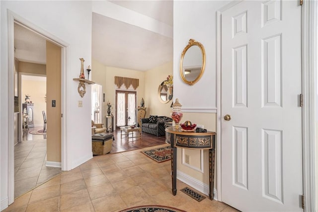 foyer featuring tile patterned floors, visible vents, and baseboards