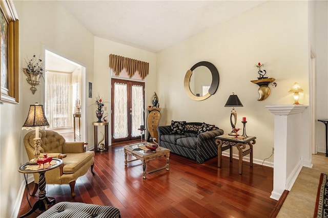 living room with wood finished floors, baseboards, and french doors