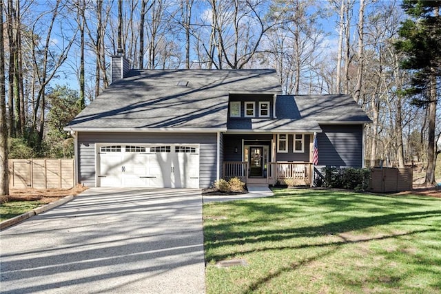 view of front facade featuring covered porch, a garage, fence, concrete driveway, and a front lawn