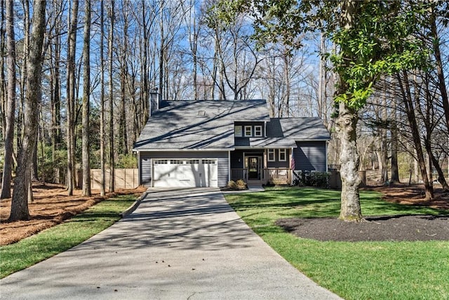 view of front of home with a chimney, aphalt driveway, a front lawn, and an attached garage