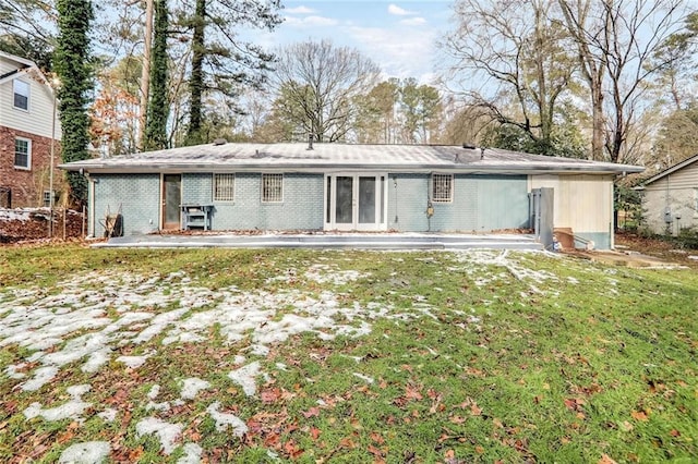 back of property featuring a yard and a patio