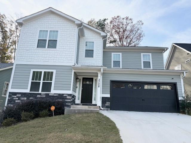 view of front of property featuring a garage and a front lawn