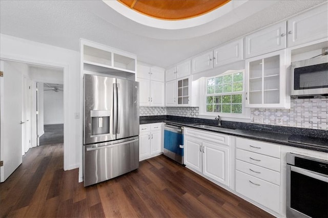 kitchen featuring appliances with stainless steel finishes, dark hardwood / wood-style flooring, white cabinetry, and sink