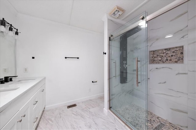 bathroom featuring walk in shower and vanity