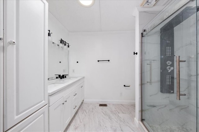 bathroom featuring a shower with shower door and vanity