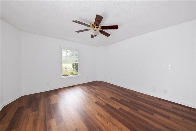 spare room featuring a textured ceiling, ceiling fan, and dark hardwood / wood-style flooring