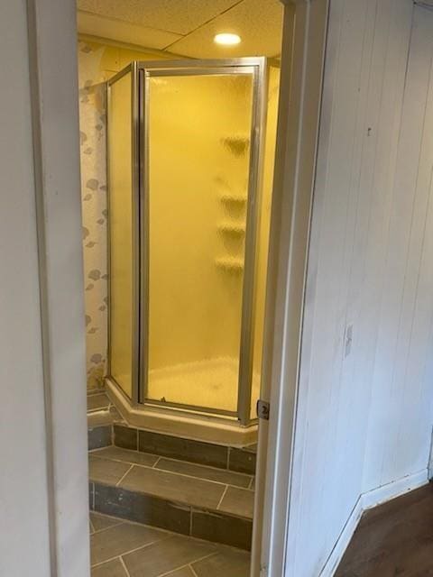 bathroom featuring a shower with shower door