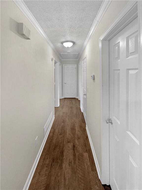 hall featuring crown molding, dark hardwood / wood-style floors, and a textured ceiling