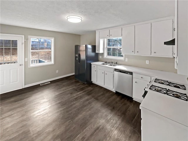 kitchen featuring white cabinetry, black refrigerator with ice dispenser, a textured ceiling, stainless steel dishwasher, and dark hardwood / wood-style flooring