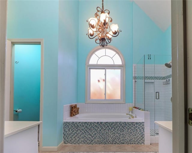 bathroom with a chandelier, a stall shower, tile patterned flooring, and a bath