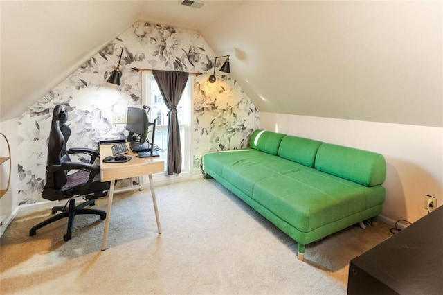 carpeted home office with lofted ceiling and visible vents