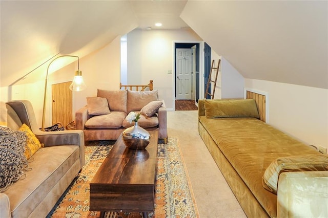 carpeted living area with lofted ceiling