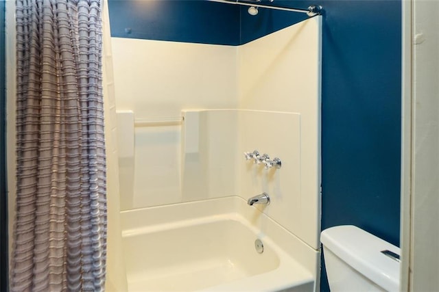 bathroom with toilet and shower / bath combination with curtain