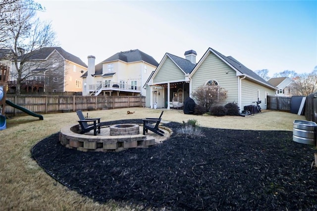 view of front of home featuring a patio area, a fenced backyard, and a fire pit