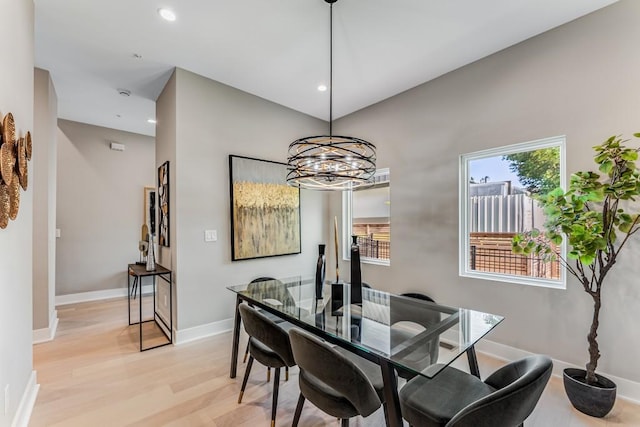 dining area featuring a chandelier and light hardwood / wood-style floors