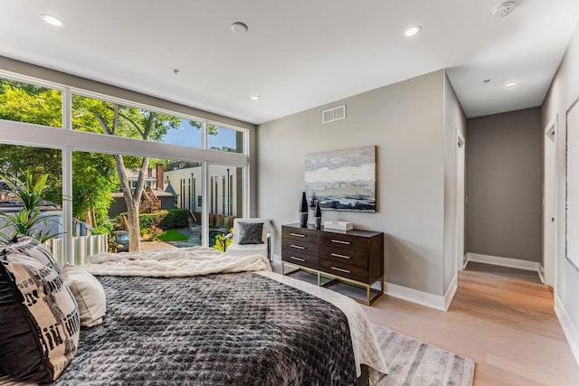 bedroom with access to outside and light hardwood / wood-style flooring